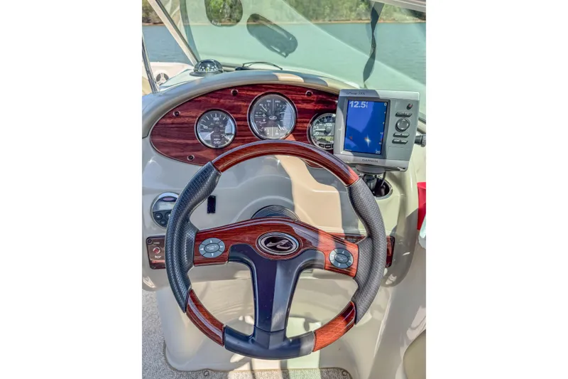 Slide: The Image of Steering wheel and dashboard of 2007 Sea Ray 220 Sundeck boat with Garmin GPS. - 9