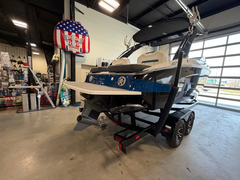 Slide: The Image of 2022 Regal LS4 Surf boat in showroom on trailer. - 3