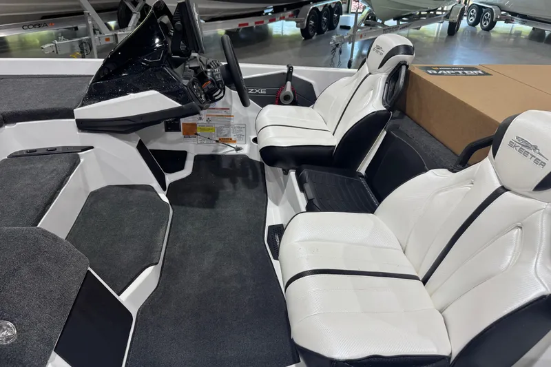 Slide: The Image of 2026 Skeeter ZXE20 boat interior with sleek white seating and modern dashboard. - 6
