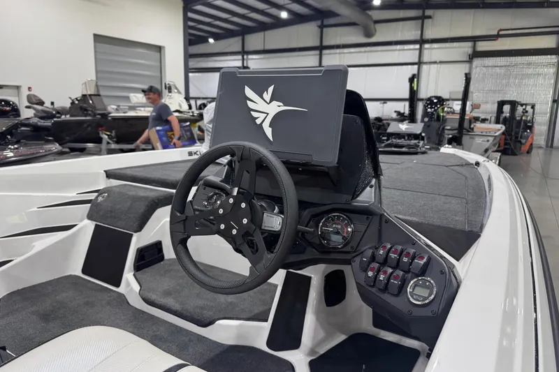 Slide: The Image of 2026 Skeeter ZXE20 boat interior with steering wheel and control panel in showroom. - 9