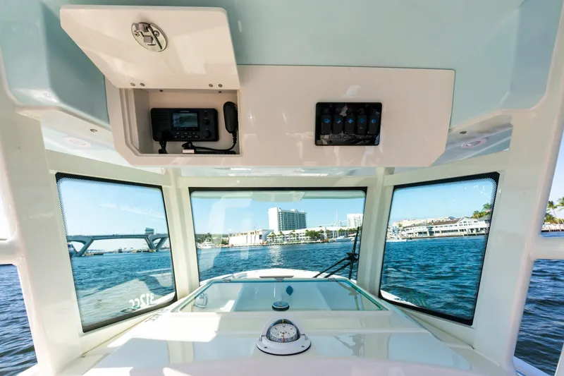 Slide: The Image of Interior view of 2027 Sailfish 312 CC boat with ocean and cityscape background. - 10