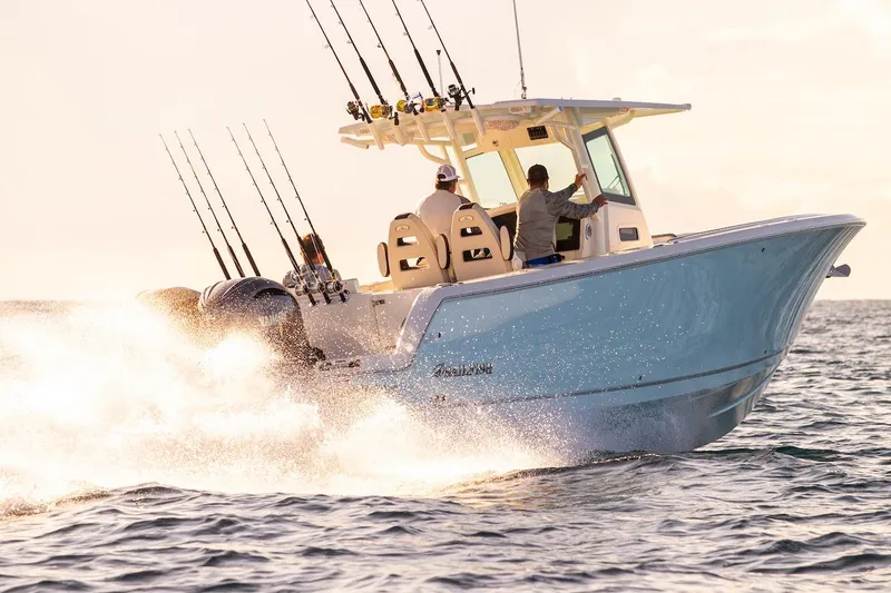 Slide: The Image of 2027 Sailfish 312 CC boat speeding on ocean with fishing rods. - 4
