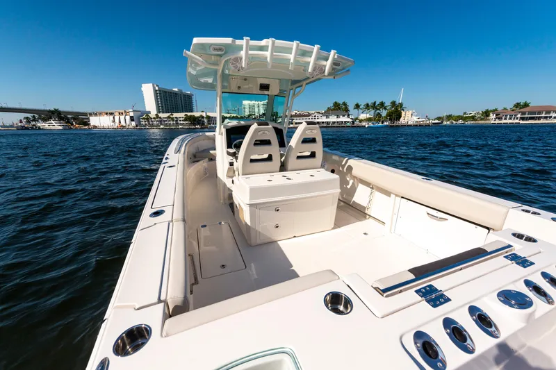 Slide: The Image of 2027 Sailfish 312 CC boat on water, clear sky, coastal background. - 5