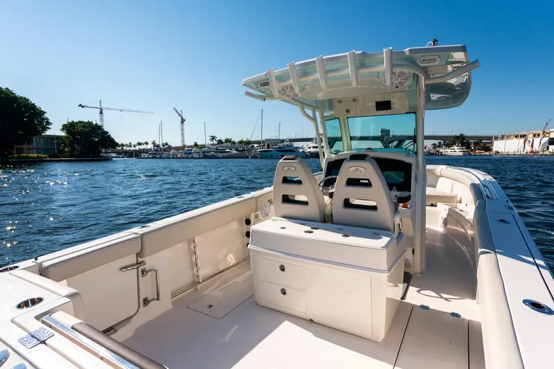 Slide: The Image of 2027 Sailfish 312 CC boat on water, featuring spacious deck and modern design. - 6