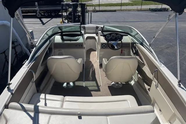 Slide: The Image of Interior view of a 2012 Sea Ray 210 SLX boat, featuring seating and steering wheel. - 10