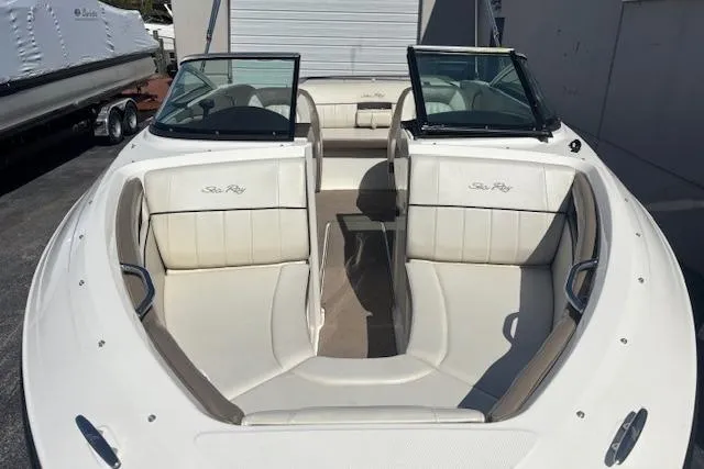 Slide: The Image of 2012 Sea Ray 210 SLX boat with white leather seating and open bow design. - 11