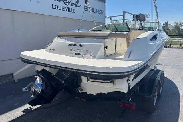 Slide: The Image of 2012 Sea Ray 210 SLX boat on trailer, rear view, parked outdoors. - 3