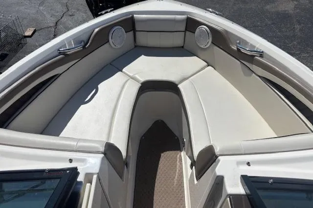 Slide: The Image of 2012 Sea Ray 210 SLX boat interior with beige seating and speakers. - 4