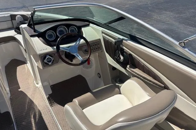 Slide: The Image of 2012 Sea Ray 210 SLX boat interior with steering wheel and dashboard controls. - 6