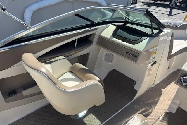 Slide: The Image of Interior view of 2012 Sea Ray 210 SLX boat with beige seating and dashboard. - 7