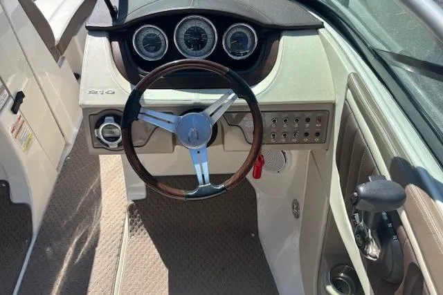 Slide: The Image of Interior view of 2012 Sea Ray 210 SLX boat dashboard with steering wheel and gauges. - 8