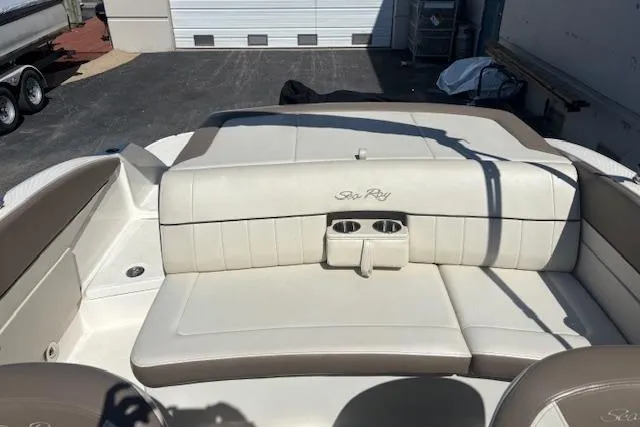 Slide: The Image of 2012 Sea Ray 210 SLX boat interior with beige seating and cup holders. - 9
