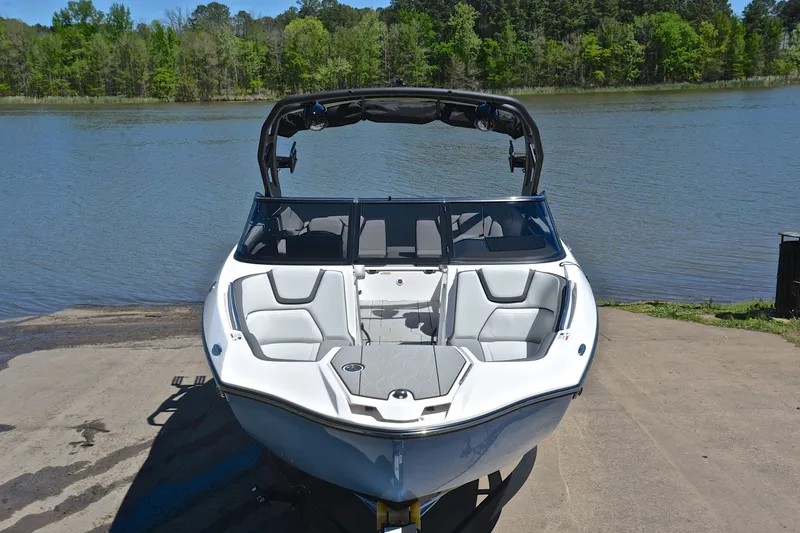 Slide: The Image of 2024 Yamaha Boats 252XE on a boat ramp by a scenic lake. - 17