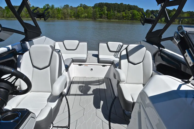 Slide: The Image of 2024 Yamaha Boats 252XE interior with sleek seating on a calm lake. - 22