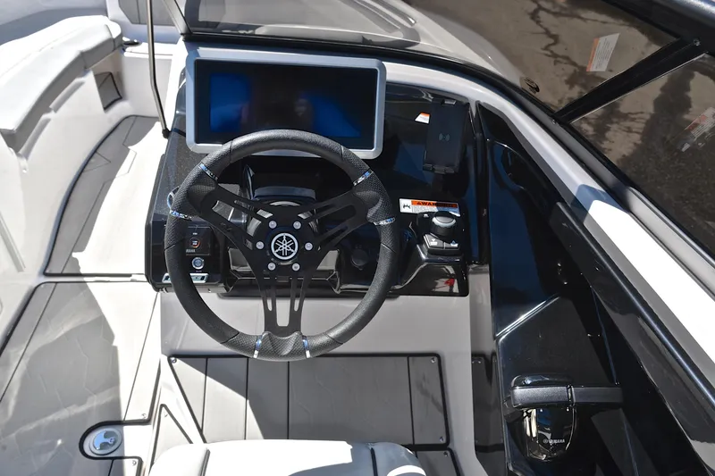 Slide: The Image of 2024 Yamaha Boats 252XE cockpit with steering wheel and touchscreen display. - 26