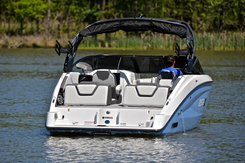 Slide: The Image of 2024 Yamaha Boats 252XE on a serene lake, showcasing sleek design and modern features. - 8