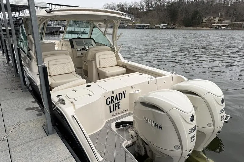 Slide: The Image of 2025 Grady-White Freedom 325 boat docked with twin Yamaha engines. - 10