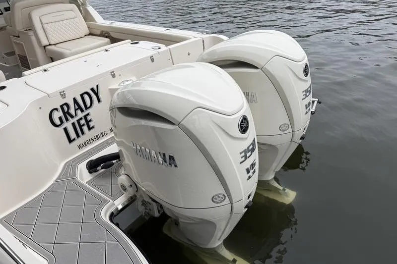 Slide: The Image of 2025 Grady-White Freedom 325 boat with twin Yamaha 350 engines on water. - 11