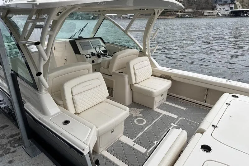 Slide: The Image of 2025 Grady-White Freedom 325 boat interior with luxurious seating and modern dashboard. - 12