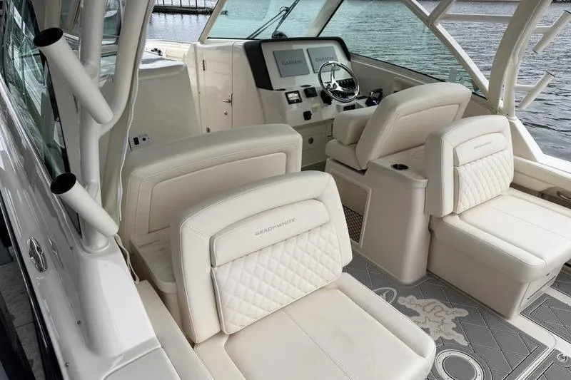 Slide: The Image of 2025 Grady-White Freedom 325 boat interior with luxurious seating and modern dashboard. - 14