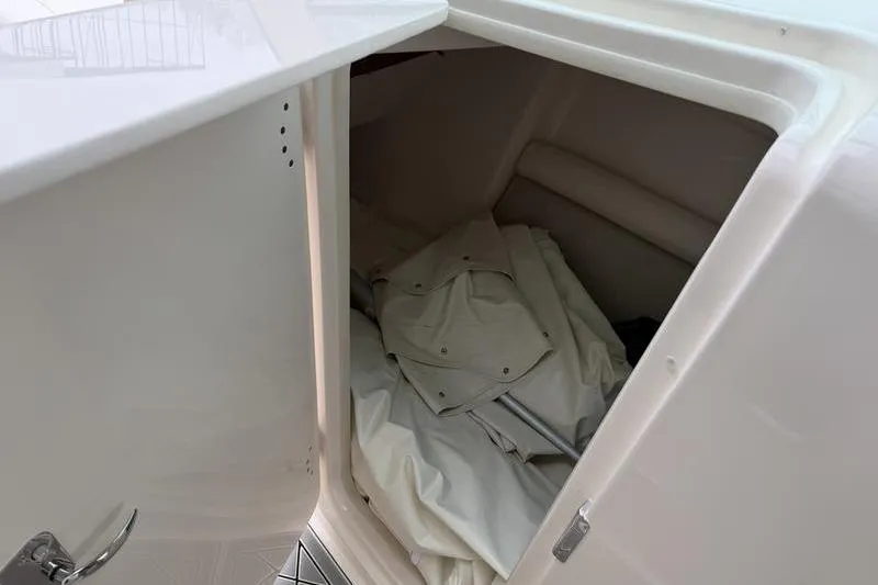 Slide: The Image of Storage compartment inside a 2025 Grady-White Freedom 325 boat, featuring folded canvas. - 15