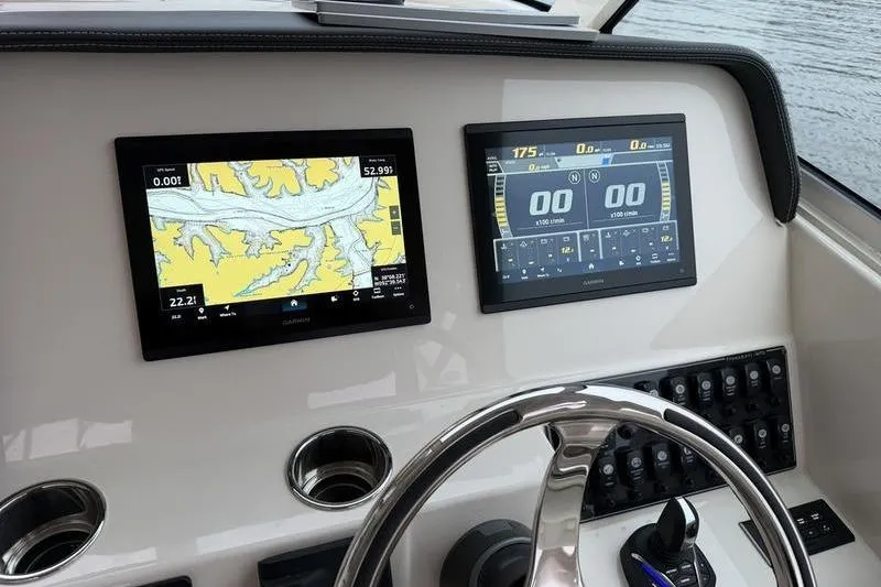 Slide: The Image of Dashboard of 2025 Grady-White Freedom 325 boat with navigation screens. - 17
