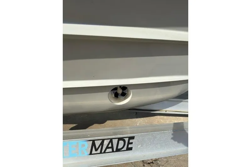 Slide: The Image of 2025 Grady-White Freedom 325 boat hull detail with trailer. - 19