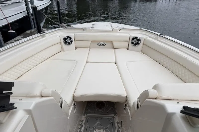 Slide: The Image of 2025 Grady-White Freedom 325 boat interior with luxurious seating and speakers. - 21