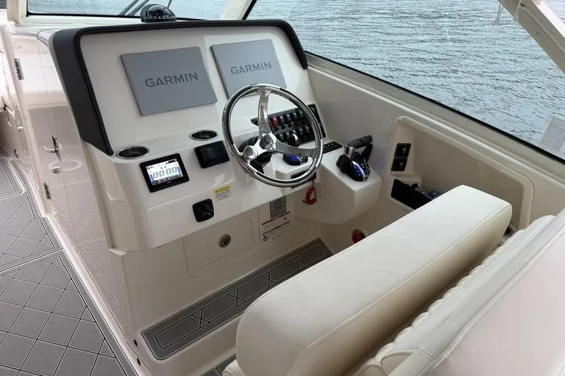Slide: The Image of Helm of 2025 Grady-White Freedom 325 boat with Garmin navigation systems. - 25