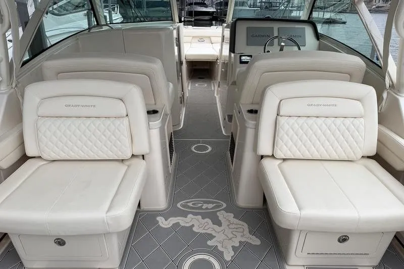 Slide: The Image of 2025 Grady-White Freedom 325 boat interior with luxurious seating and modern dashboard. - 26