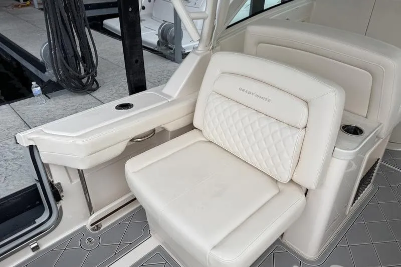 Slide: The Image of 2025 Grady-White Freedom 325 boat interior with luxurious seating and cup holders. - 27