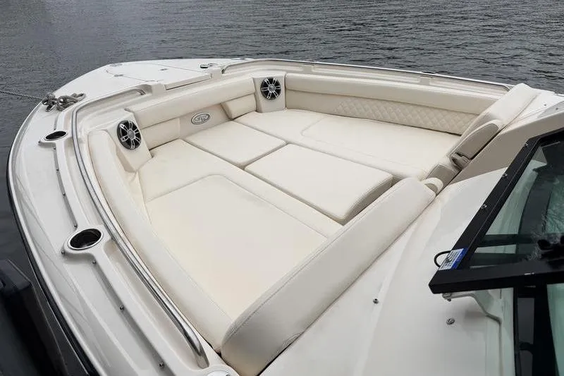 Slide: The Image of 2025 Grady-White Freedom 325 boat with spacious, luxurious seating on calm water. - 28