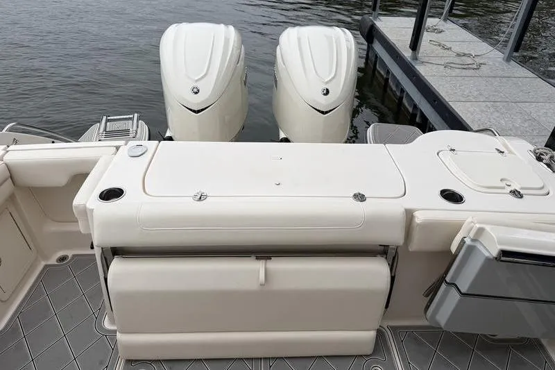 Slide: The Image of 2025 Grady-White Freedom 325 boat with dual engines docked by the water. - 29