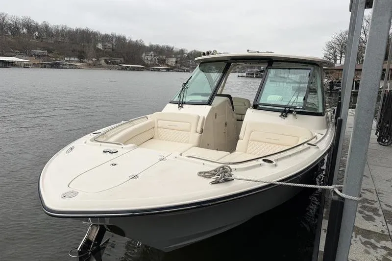 Slide: The Image of 2025 Grady-White Freedom 325 boat docked on a calm lake. - 3