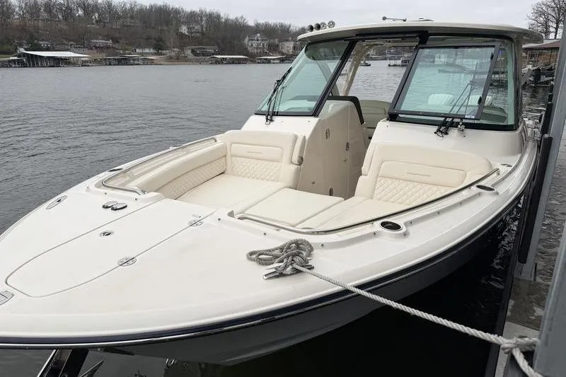 Slide: The Image of 2025 Grady-White Freedom 325 boat docked on a calm lake. - 4