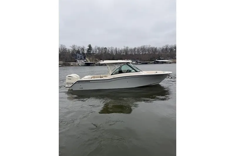 Slide: The Image of 2025 Grady-White Freedom 325 boat on calm water, overcast sky background. - 6