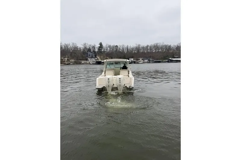 Slide: The Image of 2025 Grady-White Freedom 325 boat cruising on a calm lake. - 7