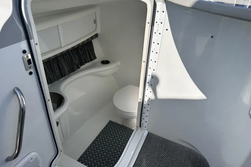 Slide: The Image of Interior of a 2006 Formula 280 Bowrider boat, featuring a compact marine toilet. - 18