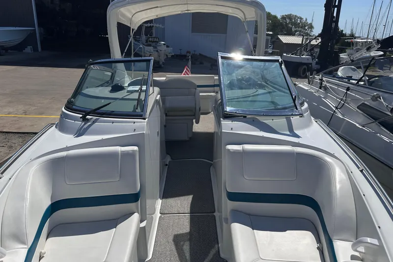 Slide: The Image of 2006 Formula 280 Bowrider boat interior with seating and windshield, docked at marina. - 24
