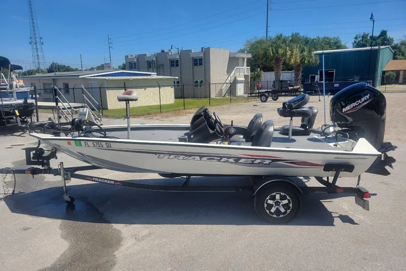 The Image of 2022 Tracker Pro Team 175 TXW boat with Mercury engine on trailer in parking lot. - 1