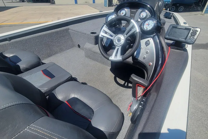Slide: The Image of 2022 Tracker Pro Team 175 TXW boat interior with steering wheel and dashboard controls. - 11