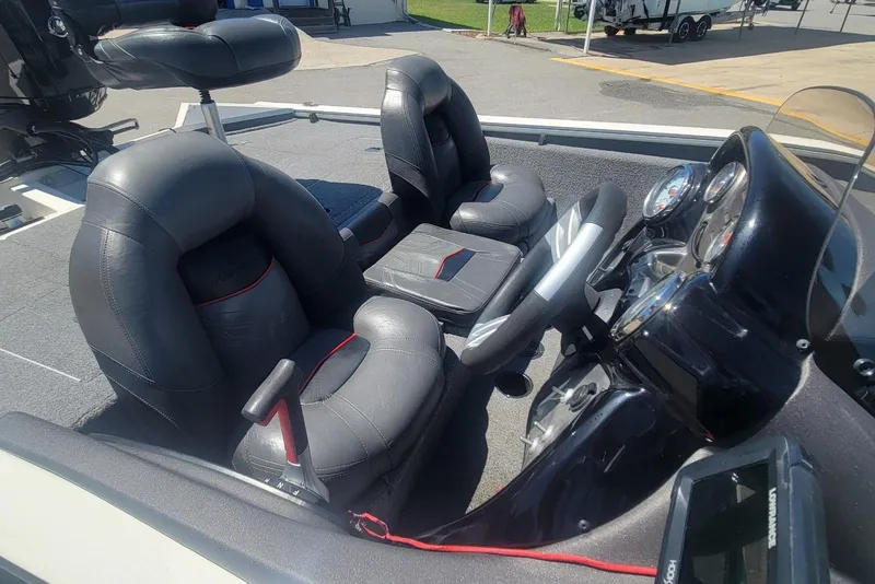 Slide: The Image of 2022 Tracker Pro Team 175 TXW boat interior with black leather seats and steering console. - 13