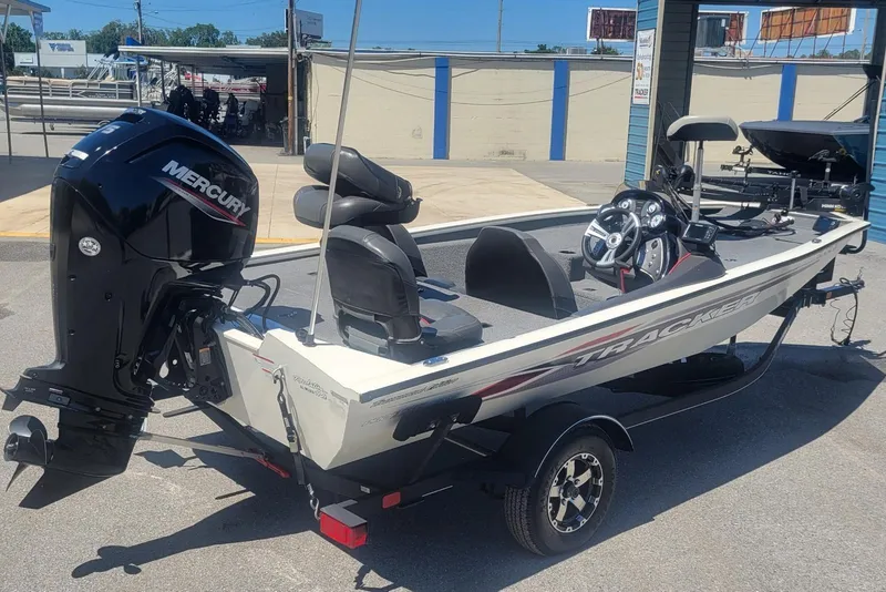 Slide: The Image of 2022 Tracker Pro Team 175 TXW boat with Mercury engine, parked outdoors. - 3
