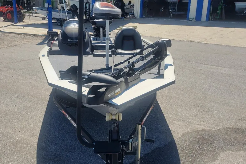 Slide: The Image of 2022 Tracker Pro Team 175 TXW boat with Minn Kota trolling motor in a parking lot. - 5