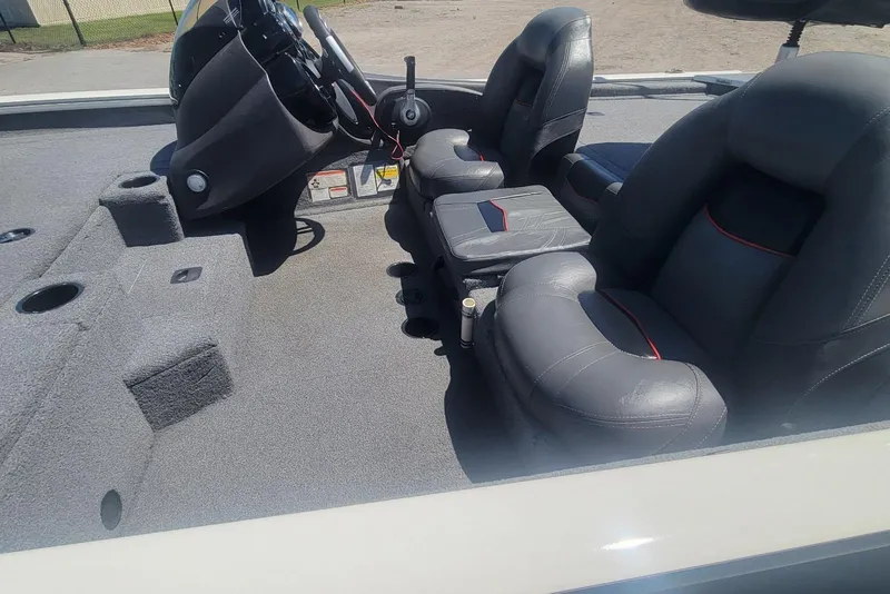 Slide: The Image of 2022 Tracker Pro Team 175 TXW boat interior with gray seating and steering console. - 8