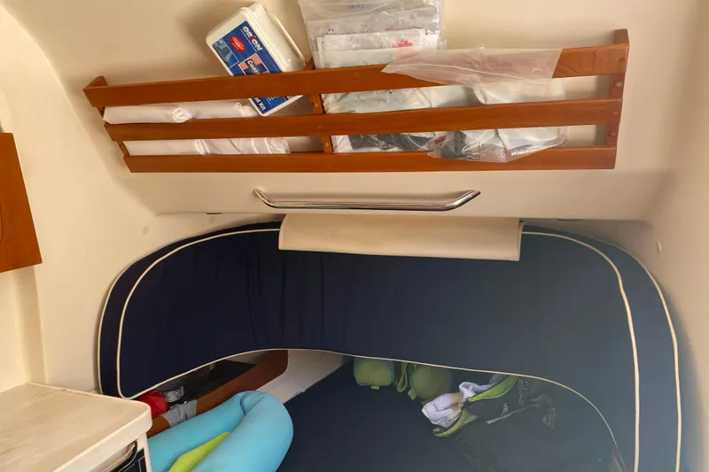 Slide: The Image of Interior cabin of 2021 Grady-White Canyon 376 with storage and bedding. - 11