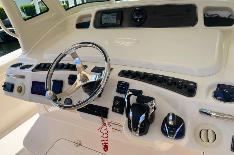 Slide: The Image of 2021 Grady-White Canyon 376 helm with steering wheel and control panel. - 12