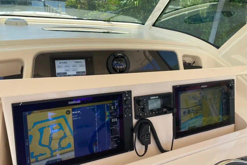 Slide: The Image of 2021 Grady-White Canyon 376 helm with Simrad navigation displays and controls. - 18