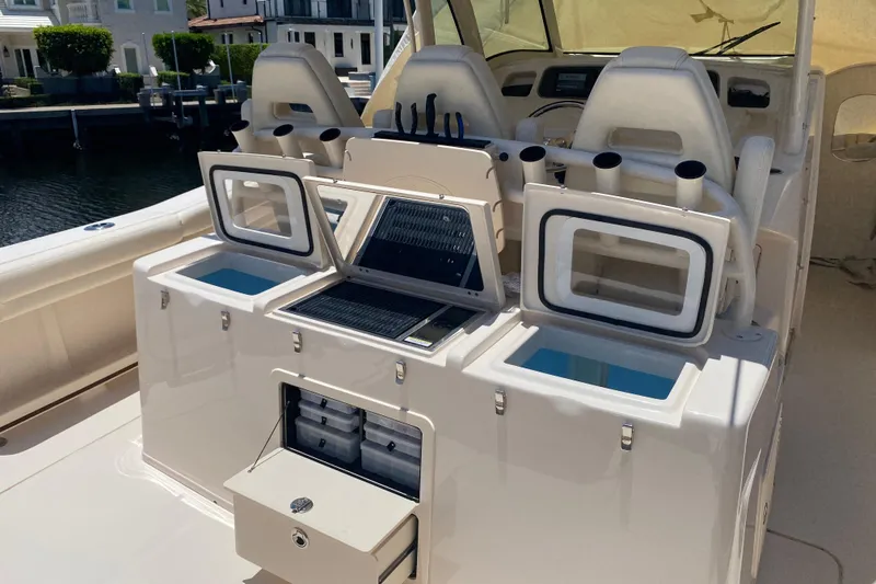 Slide: The Image of 2021 Grady-White Canyon 376 boat interior with fishing rod holders and storage compartments. - 21