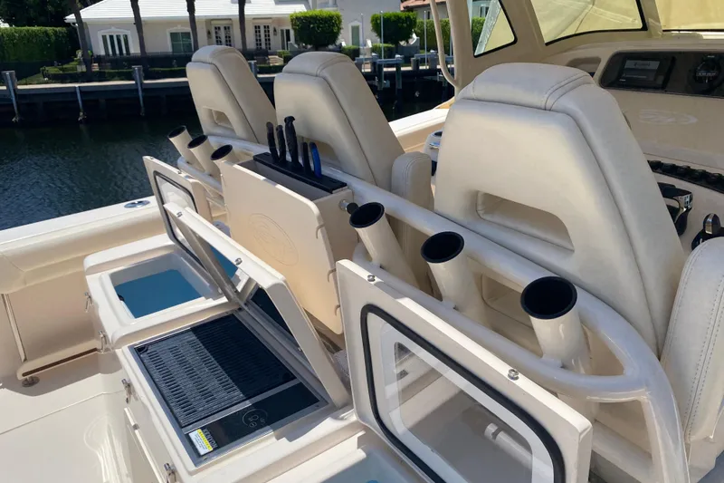 Slide: The Image of 2021 Grady-White Canyon 376 boat interior with rod holders and seating. - 22